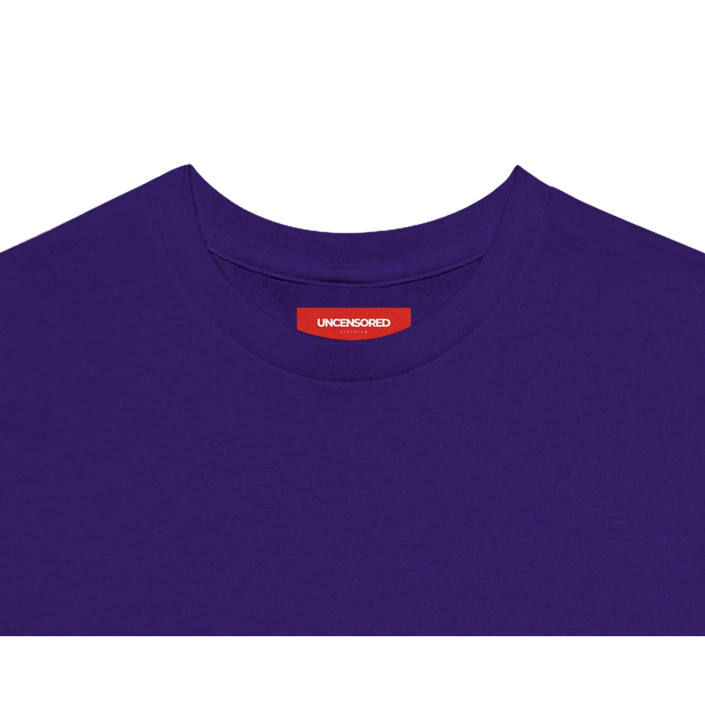 Close-up of the neckline of a purple T-shirt, featuring a red label with the "UNCENSORED" Clothing branding. Soft fabric with a clean and minimalistic finish.