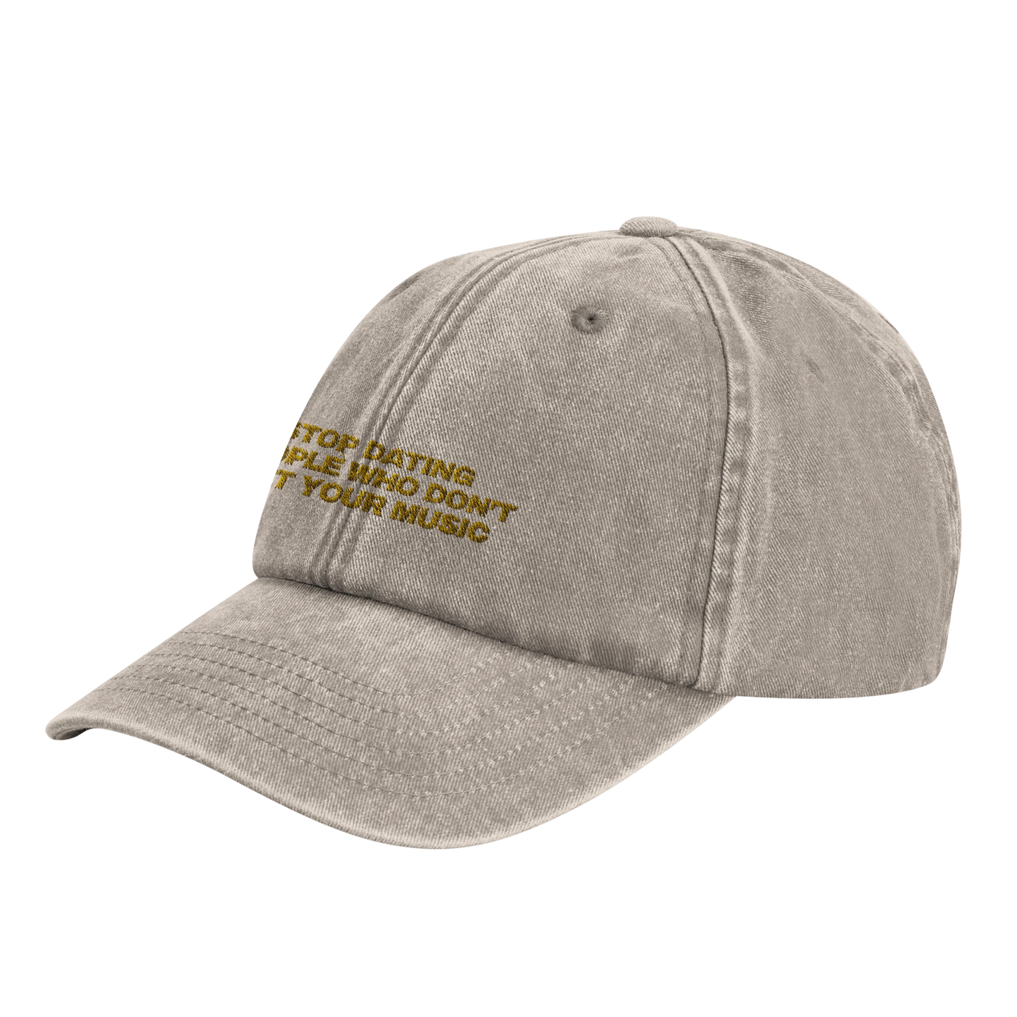 Beige baseball cap with yellow gold embroidery that reads 'Stop Dating People Who Don’t Get Your Music', shown from the front. Casual unisex design. Viral statement. 45 degree front-side view.