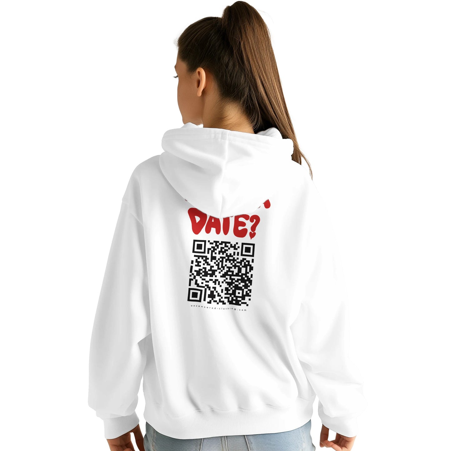 A young woman wearing a white hoodie, showing the back design. The hoodie features bold red text saying "WANNA DATE?" above a large black QR code. Below the QR code, the website "uncensored-clothing.com" is printed. The fit is slightly oversized, and the model is styled casually with jeans.