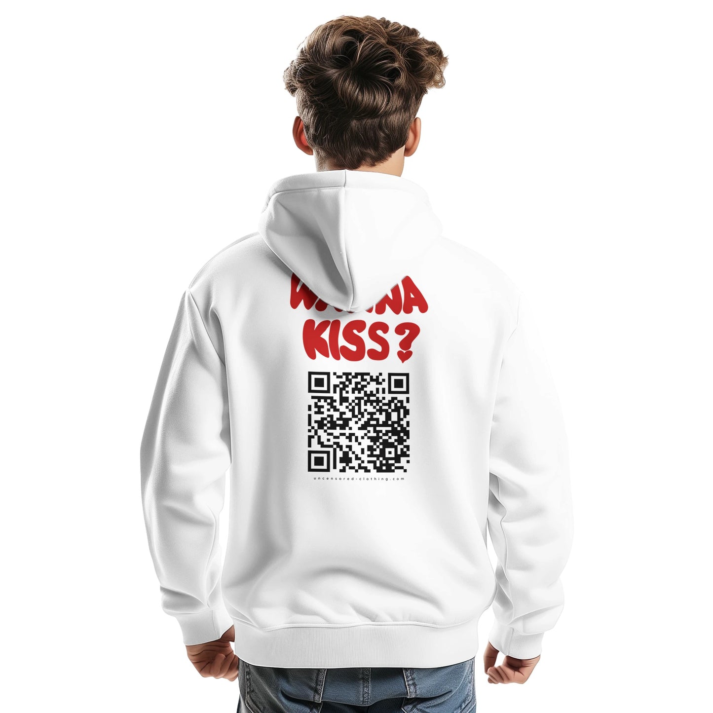 A young man wearing a white hoodie, shown from the back. The hoodie features bold red text saying "WANNA KISS?" above a large black QR code. Below the QR code, the website "uncensored-clothing.com" is printed. The hoodie has a relaxed fit, and the model is casually posing with one hand slightly clenched.