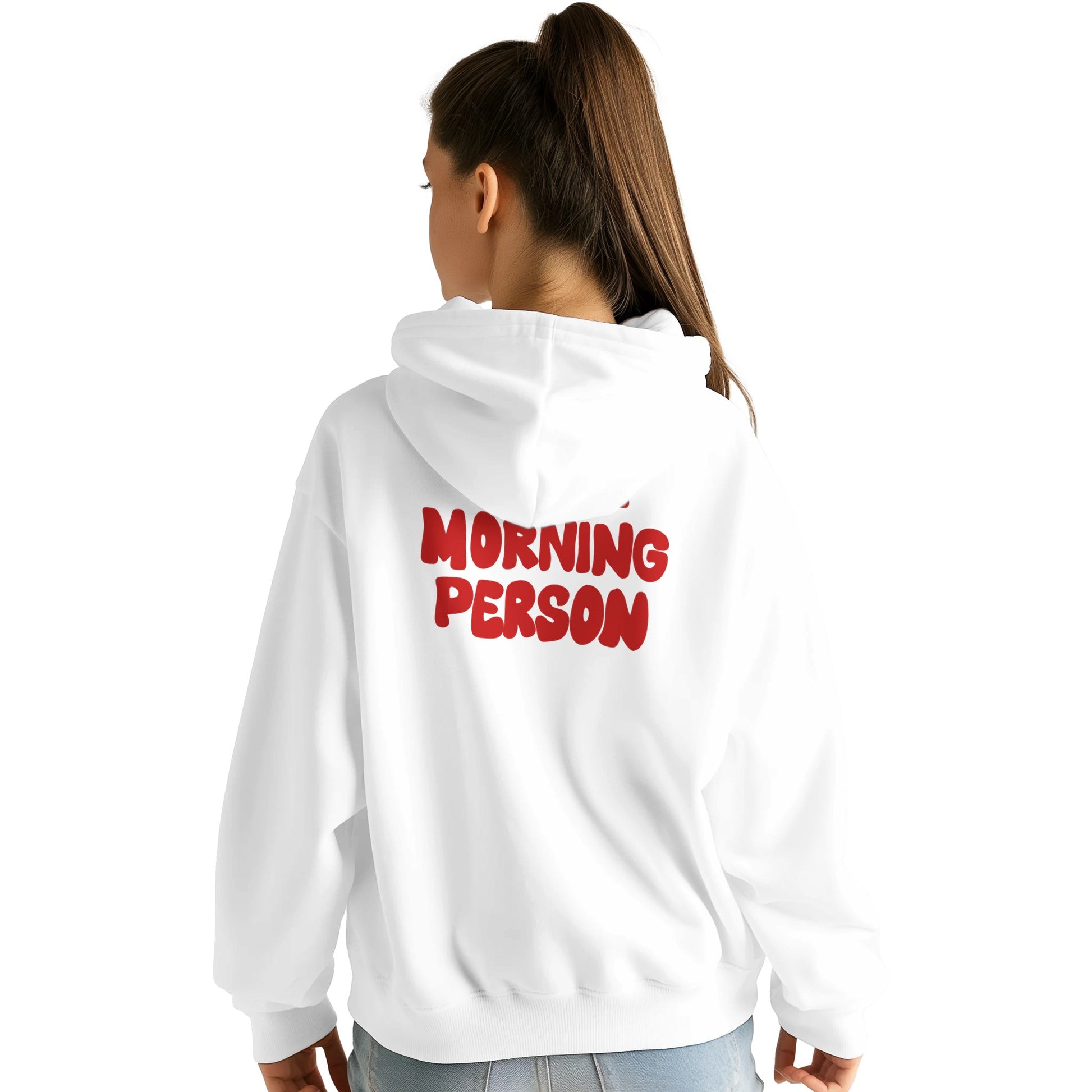 A young woman wearing a white hoodie with the phrase "MORNING PERSON" printed in bold red letters on the back. The hoodie has a relaxed fit, a large hood, and long sleeves. She is standing with her back to the camera, her head slightly turned to the side, showcasing the design against a plain white background.